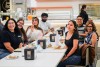 A group of students sit at a lunch table in Coyote Commons to have lunch with CSUSB president Terri Gomez